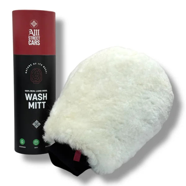 A white merino wool car wash mitt next to its black and red packaging box with the text 'WASH MITT' visible.