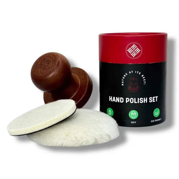 A car polishing set including a wooden handle, a red container with a white label, and two white wool pads.