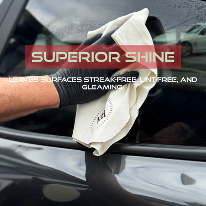 Person cleaning a car window with a white cloth, with text about superior shine.
